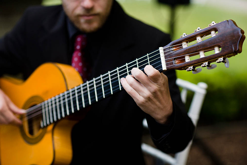 John Clarke playing guitar at a wedding